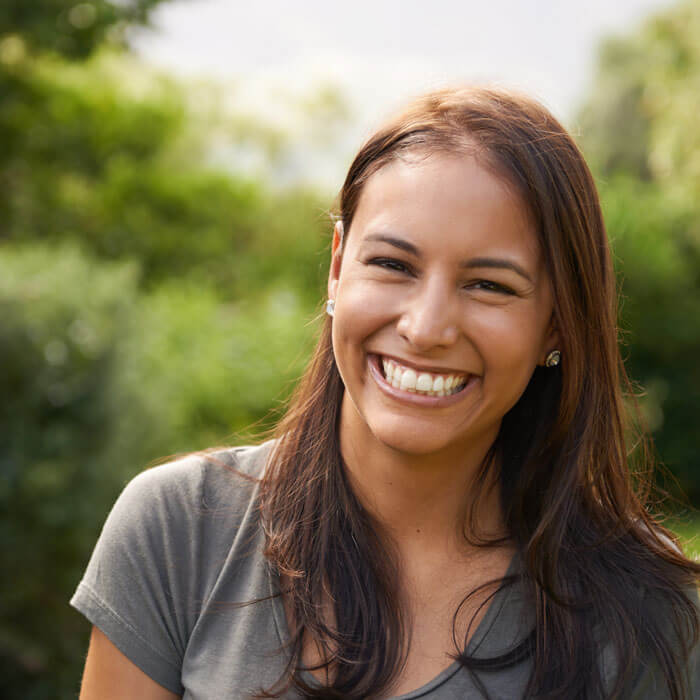 young woman smiling outdoors