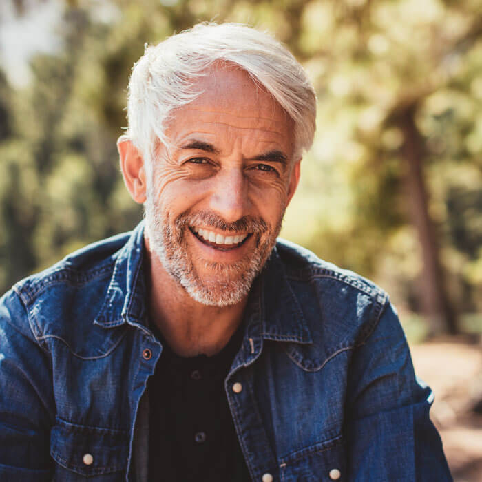 mature man smiling outdoors