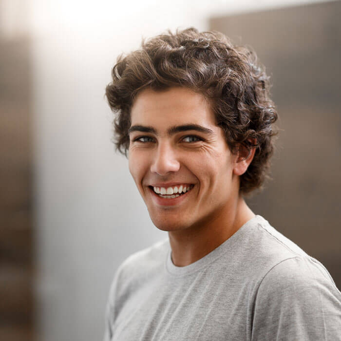 young man smiling indoors